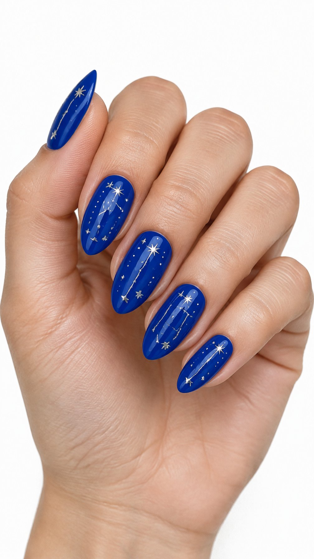 One hand with glossy electric blue nails decorated with silver constellation lines and stars against a white background.