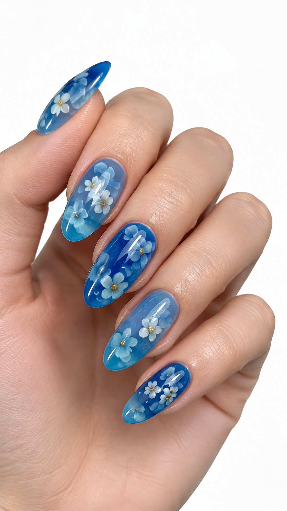 A single hand with glossy translucent ocean-blue nails decorated with tiny floating white and blue flowers on a white background.