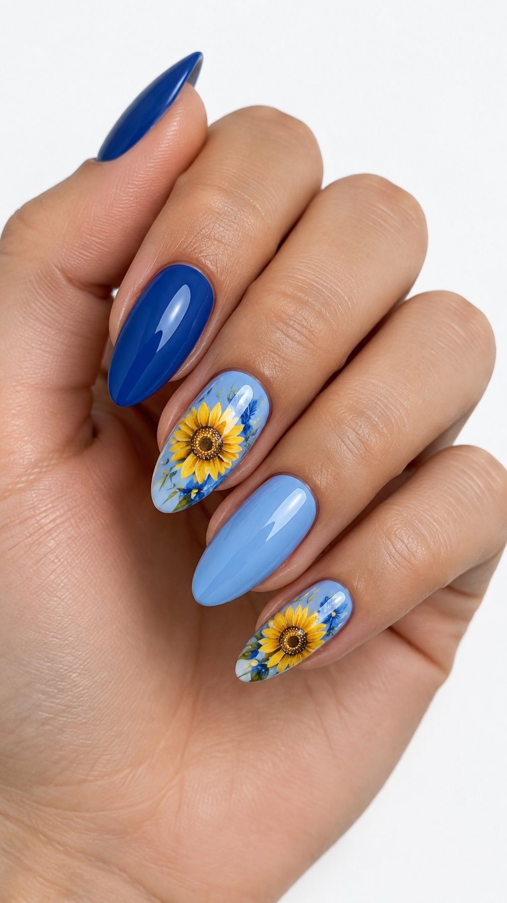 One hand with glossy blue nails and yellow sunflower designs on a white background.