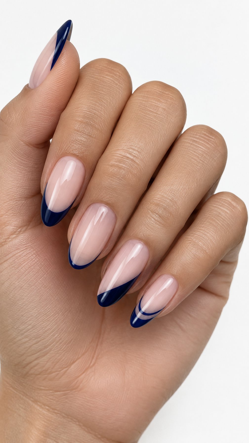 A single hand with five glossy midnight blue mismatched French manicure nails on a white background.