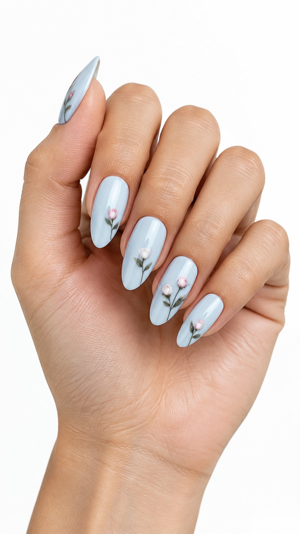 A single hand with pale blue almond-shaped nails decorated with tiny pink rosebuds and green leaves.