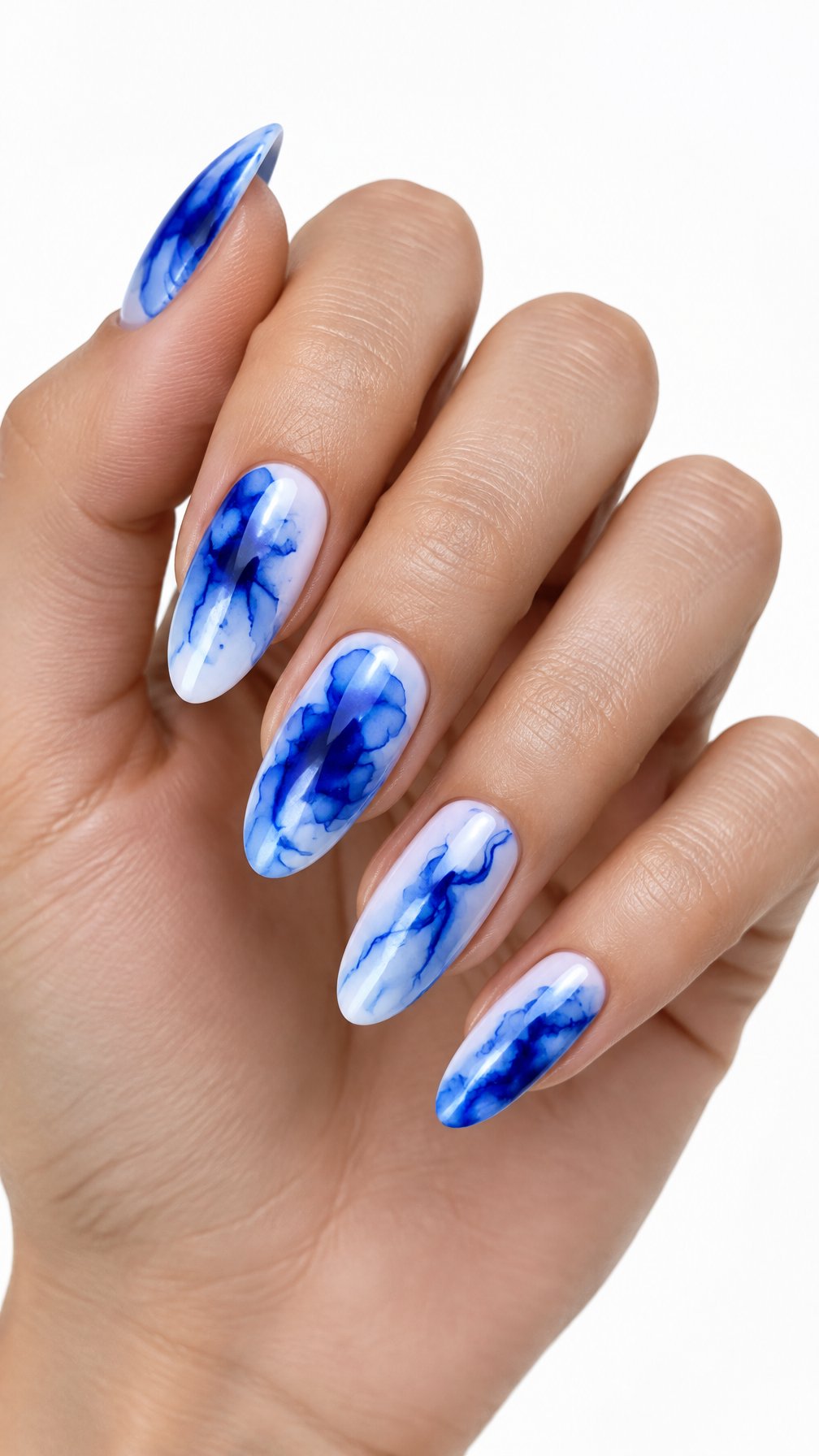 A single hand with glossy almond-shaped nails decorated with vivid blue abstract patterns on a white background.