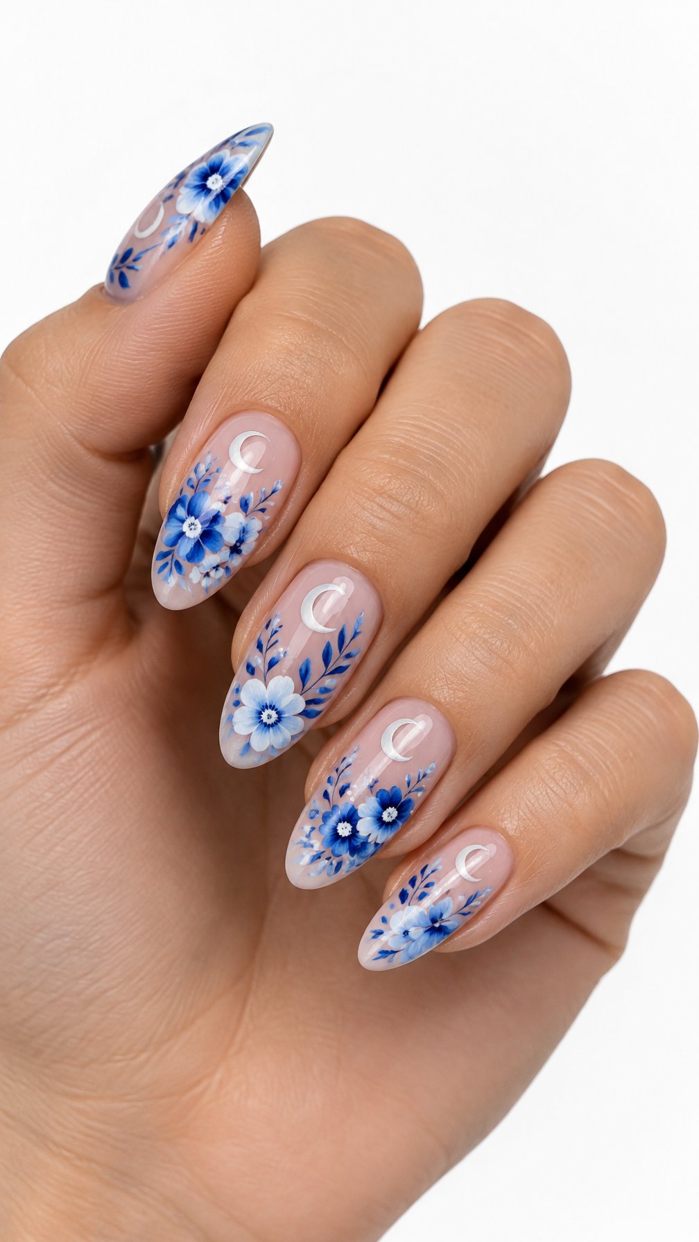 A single hand with glossy blue floral and crescent moon nail designs against a white background.
