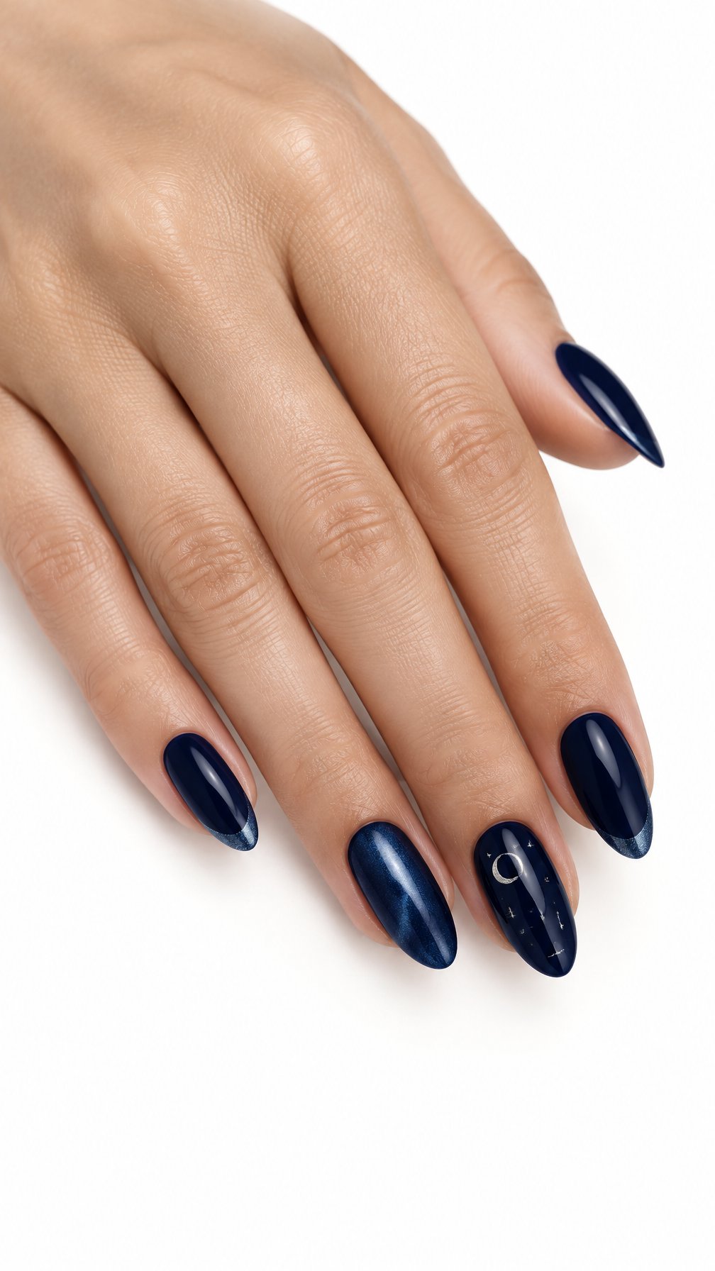 One hand with neatly manicured midnight blue nails featuring subtle shimmer, French tips, and delicate celestial accents against a white background.