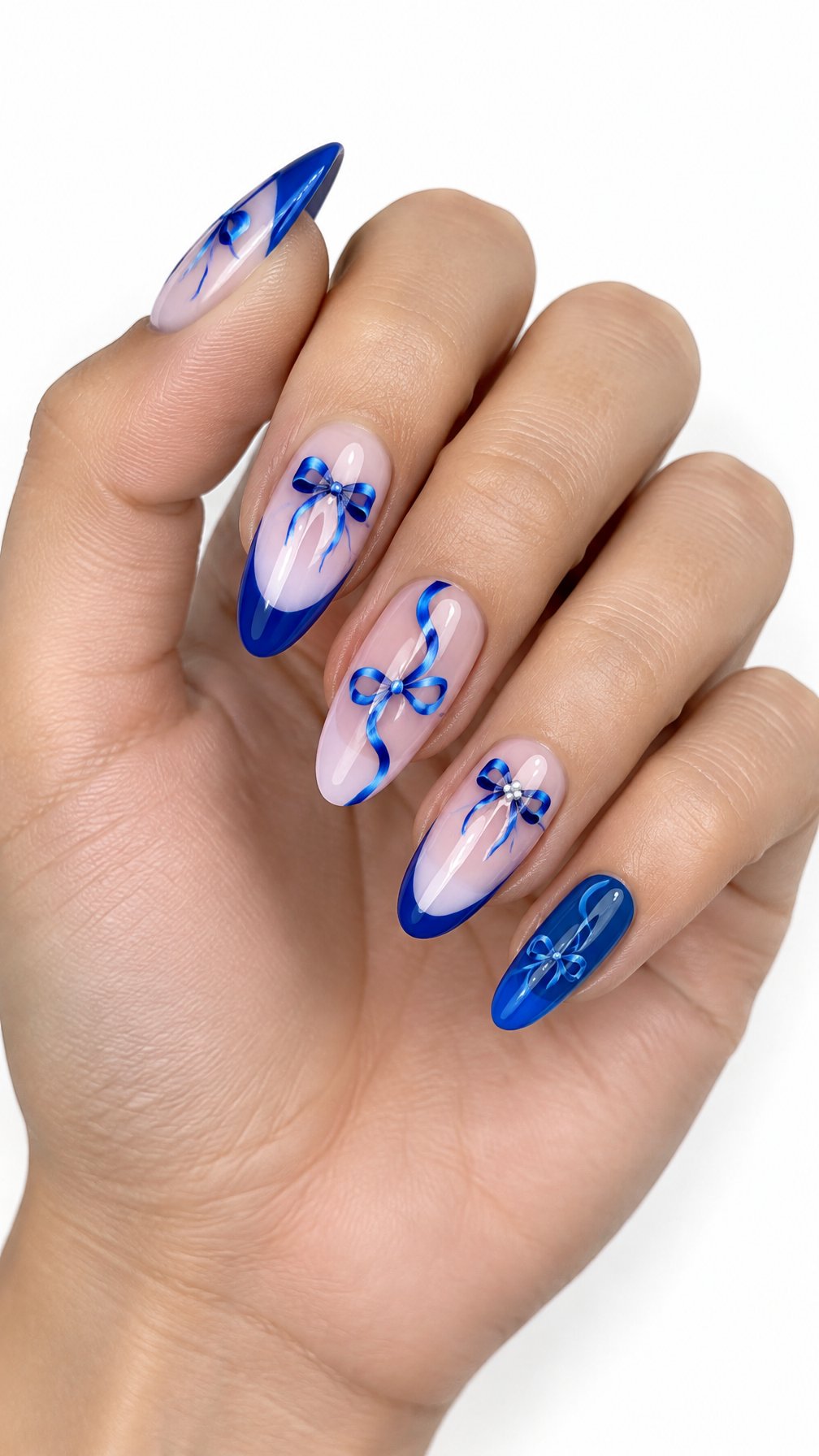 A single hand with glossy electric blue nails decorated with delicate ribbon and bow designs on a white background.