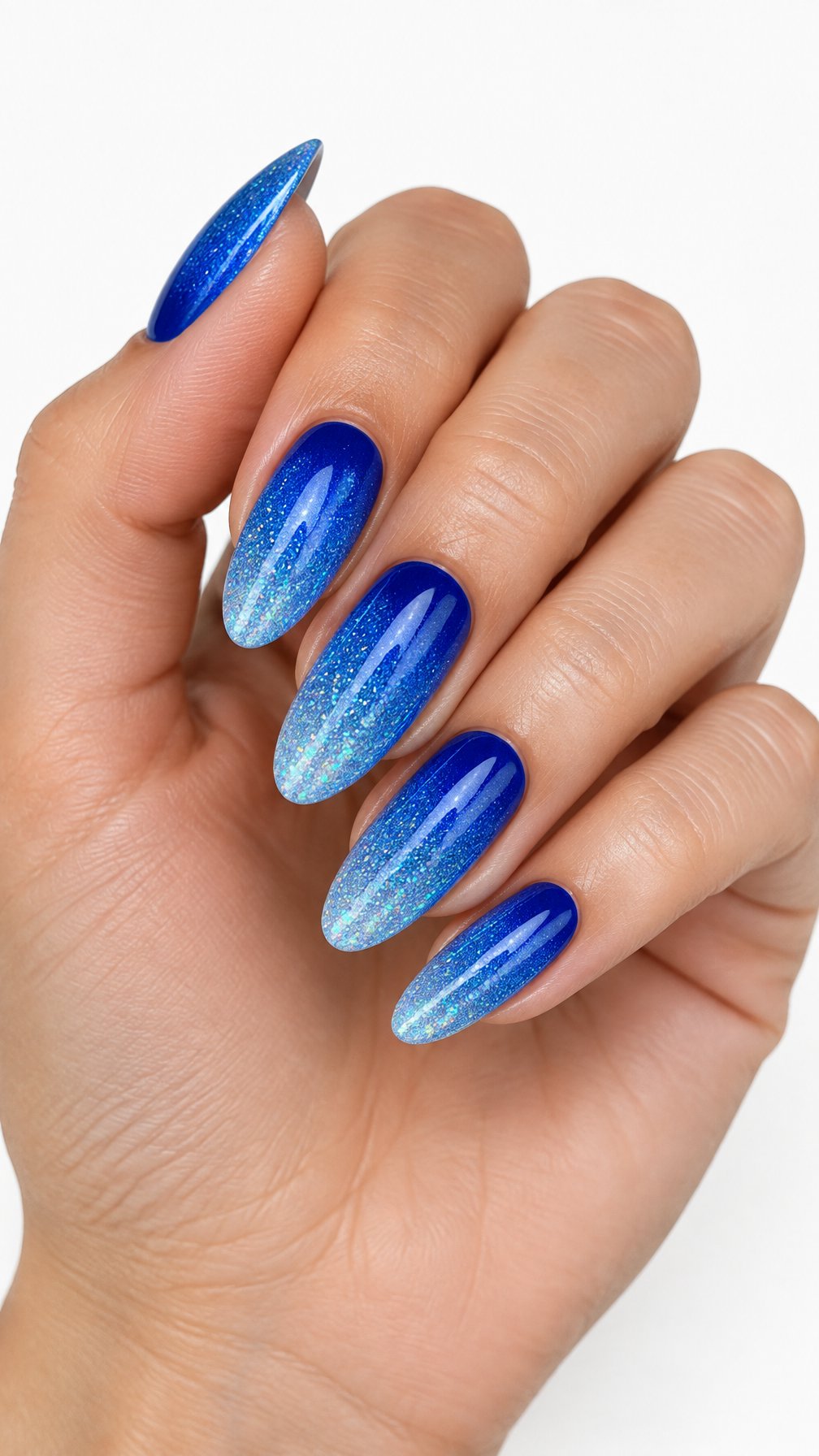 A single hand displays five glossy electric blue glitter-gradient manicure nails against a white background.