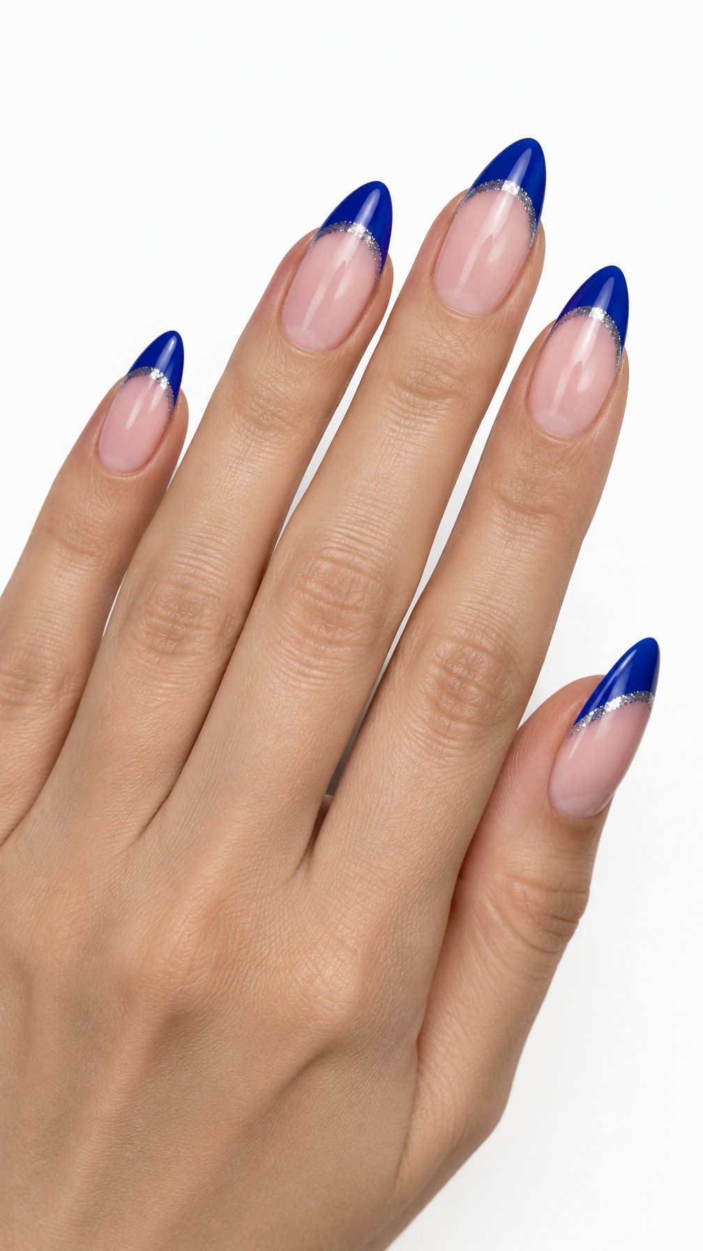 A single hand displays almond-shaped nails with royal blue French tips and silver glitter accents against a white background.