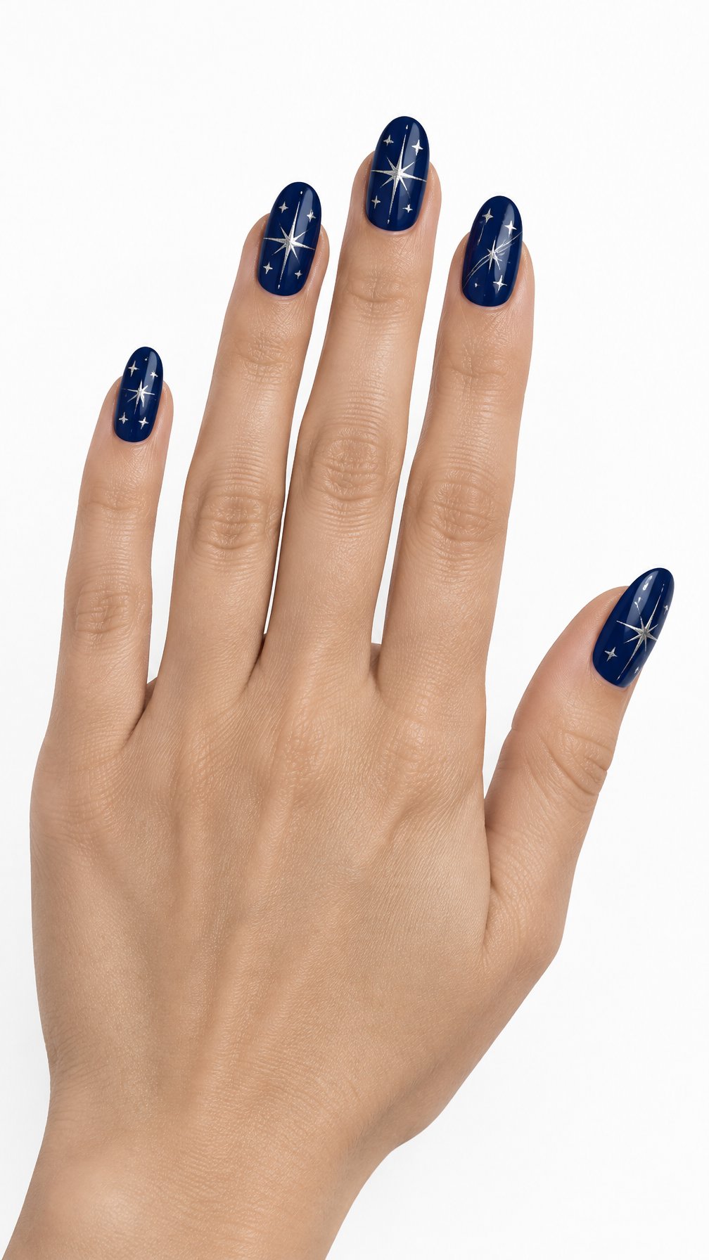 A single hand with glossy navy blue nails decorated with silver starbursts rests against a white background.