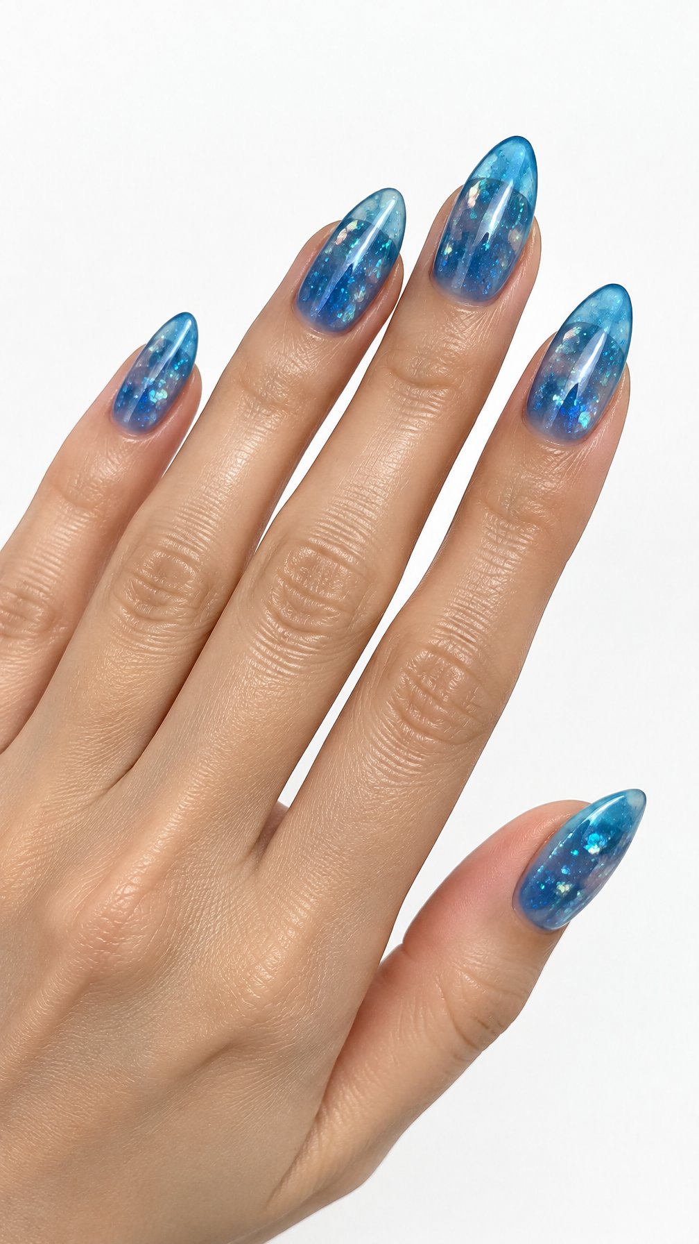 A single hand with glossy translucent ocean-blue nails decorated with fine glitter against a white background.