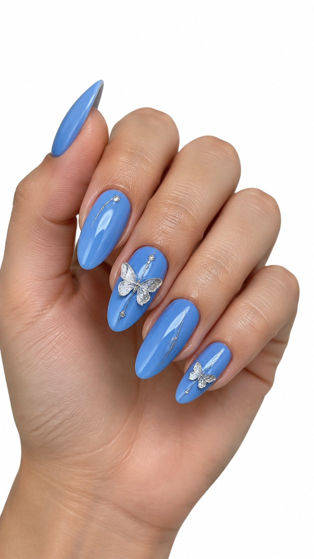 A single hand with glossy cornflower blue almond-shaped nails decorated with raised silver butterfly accents on a white background.
