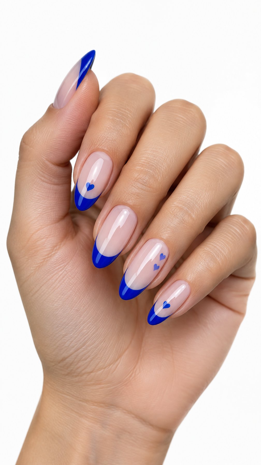 One hand with glossy cobalt blue French-tip nails and small heart details against a white background.