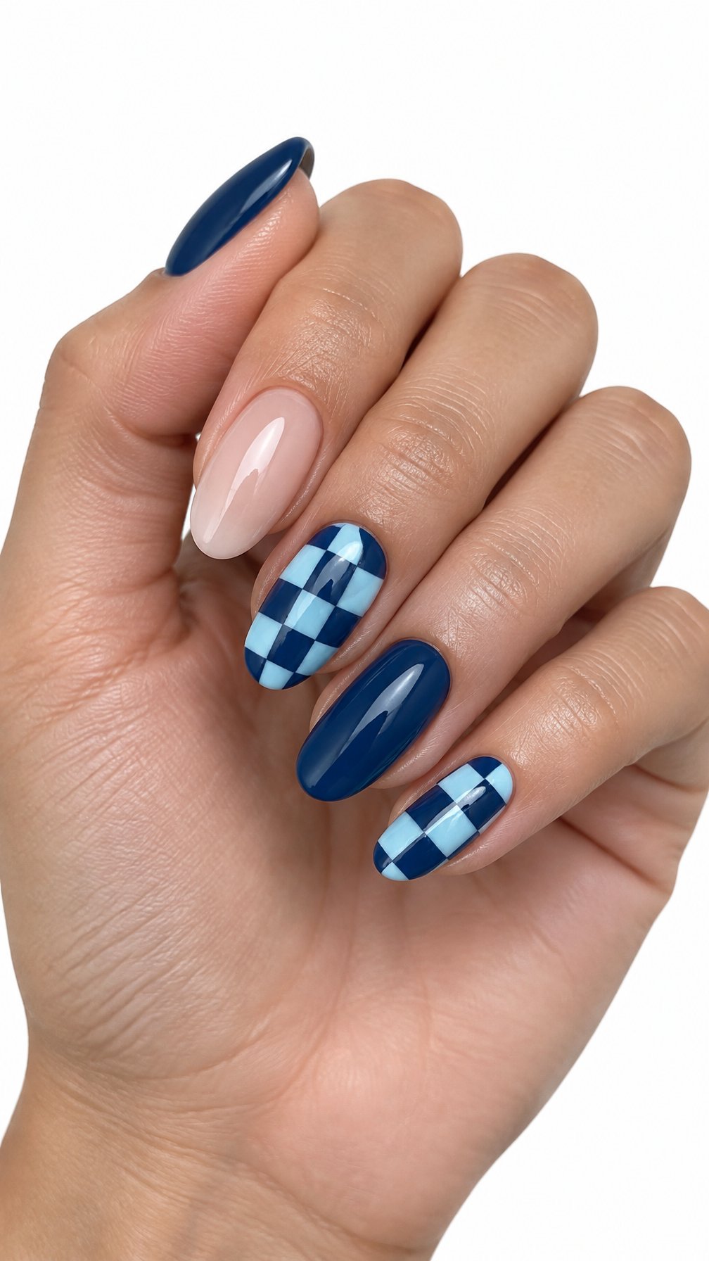 A single manicured hand with navy blue and baby blue checkerboard accent nails on a white background.