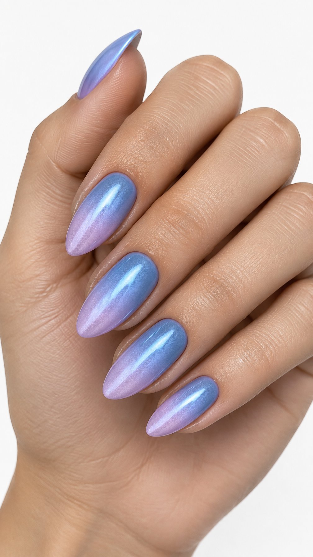 A single hand displays almond-shaped nails with a blue-to-lilac gradient and a subtle chrome finish against a white background.