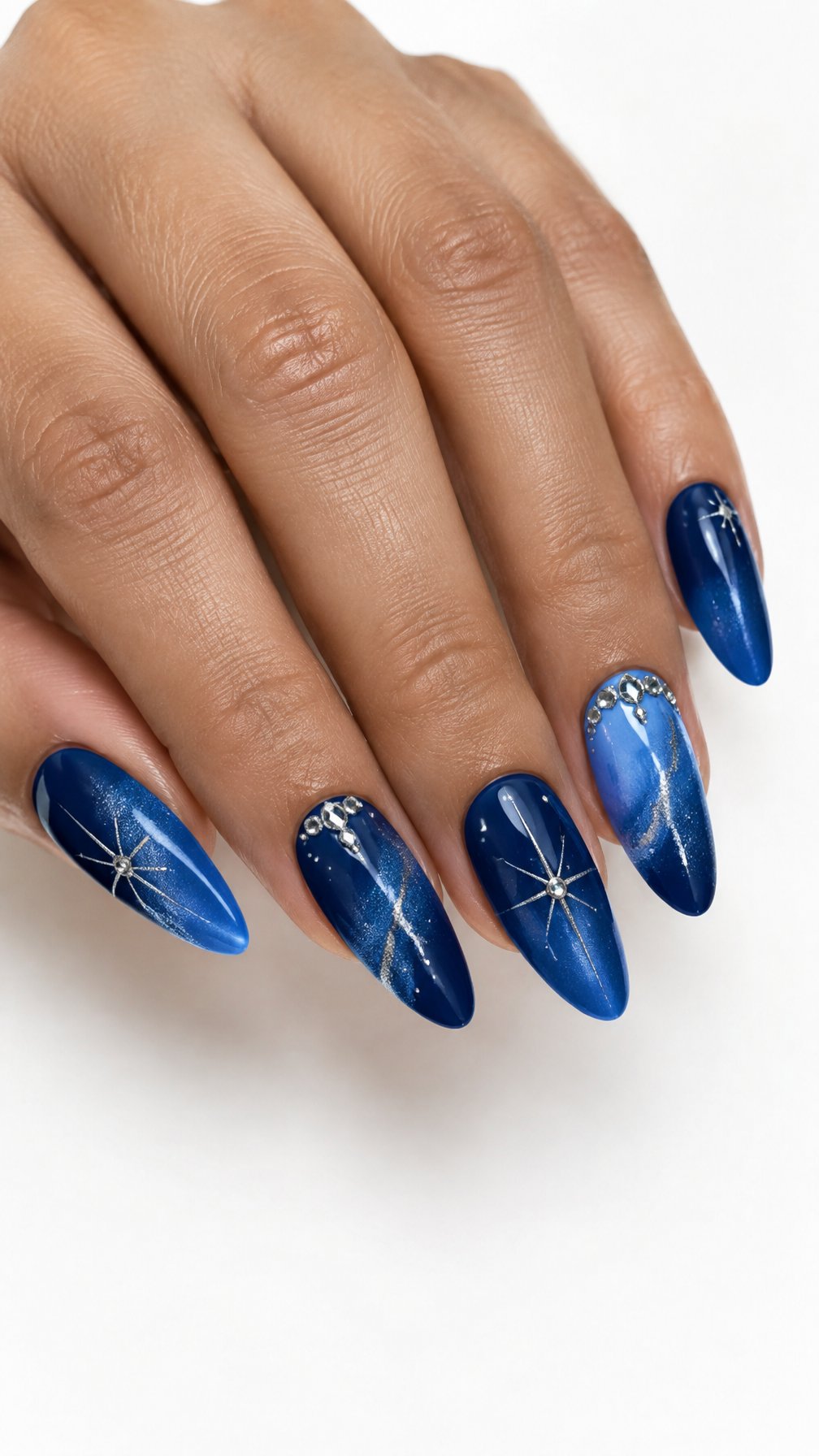 A single hand with glossy blue almond-shaped nails featuring delicate shimmer and fine decorative details against a white background.