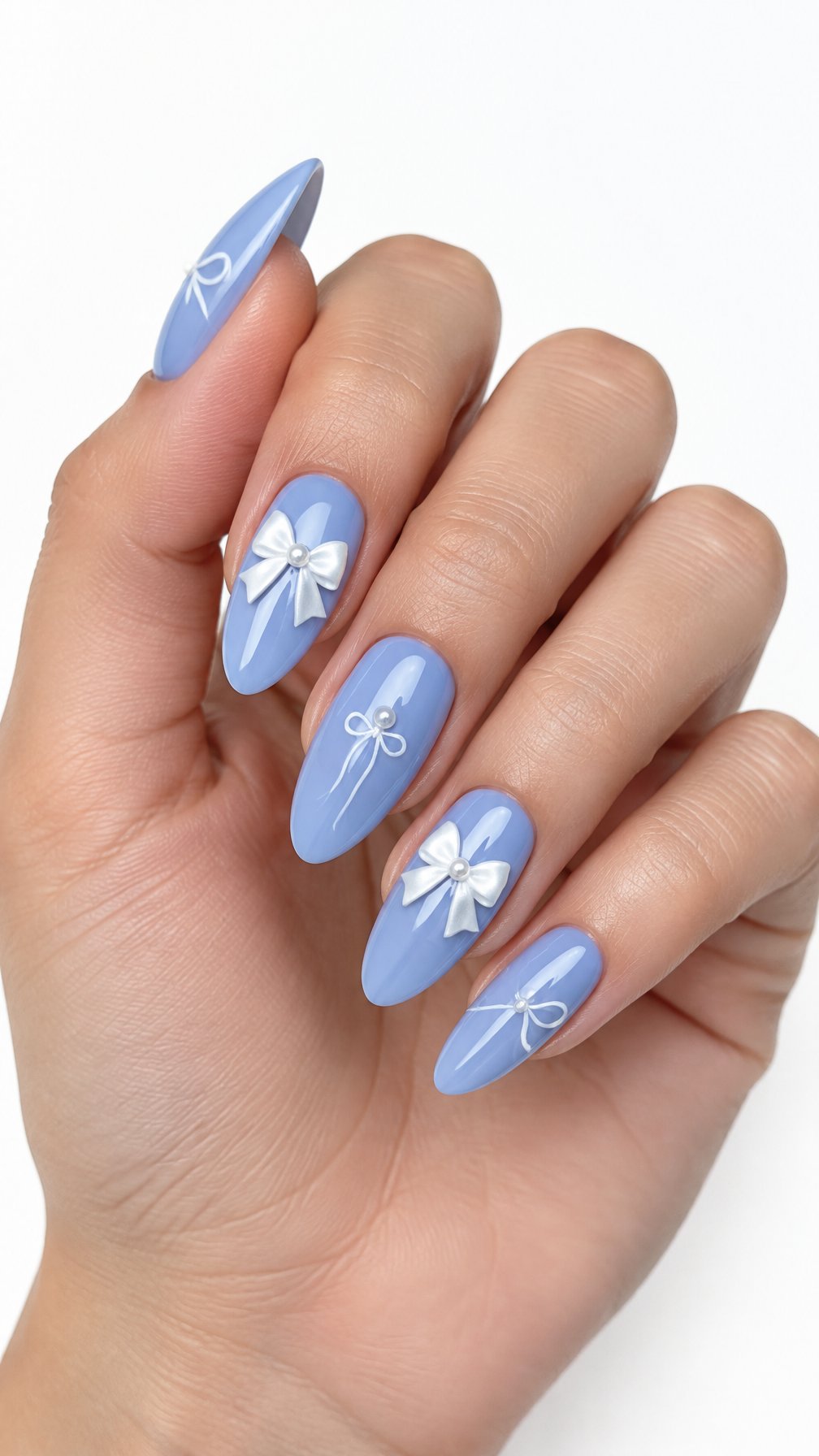 A single hand with glossy periwinkle blue almond-shaped nails decorated with delicate white bows on a white background.