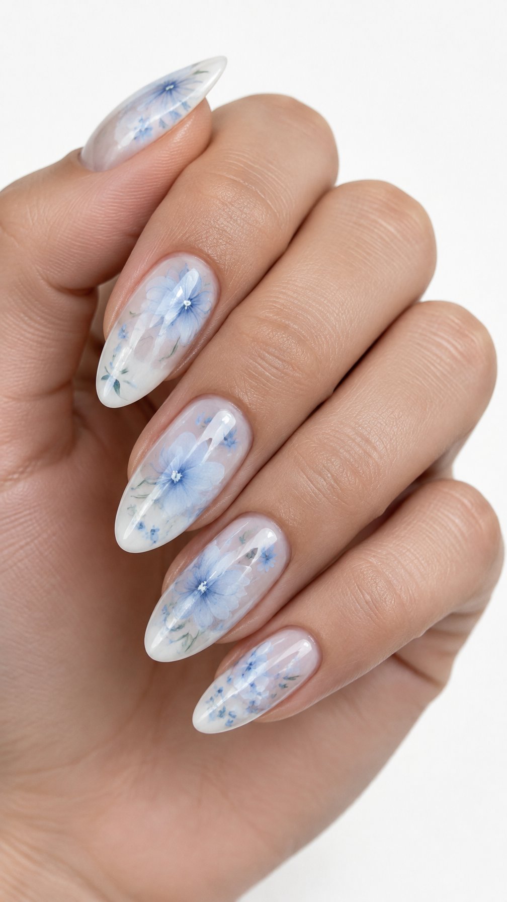 A single hand with almond-shaped nails decorated with delicate blue and white floral designs.