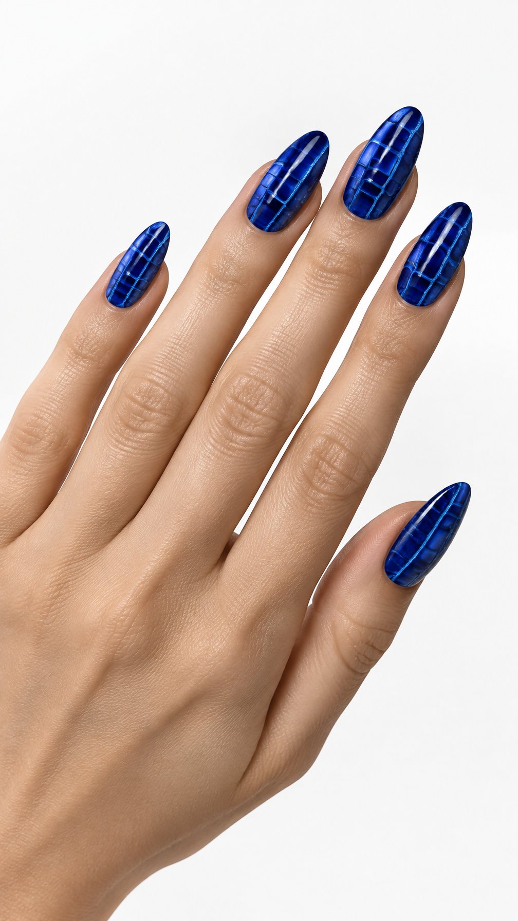 One hand with glossy blue crocodile-textured almond-shaped nails against a white background.