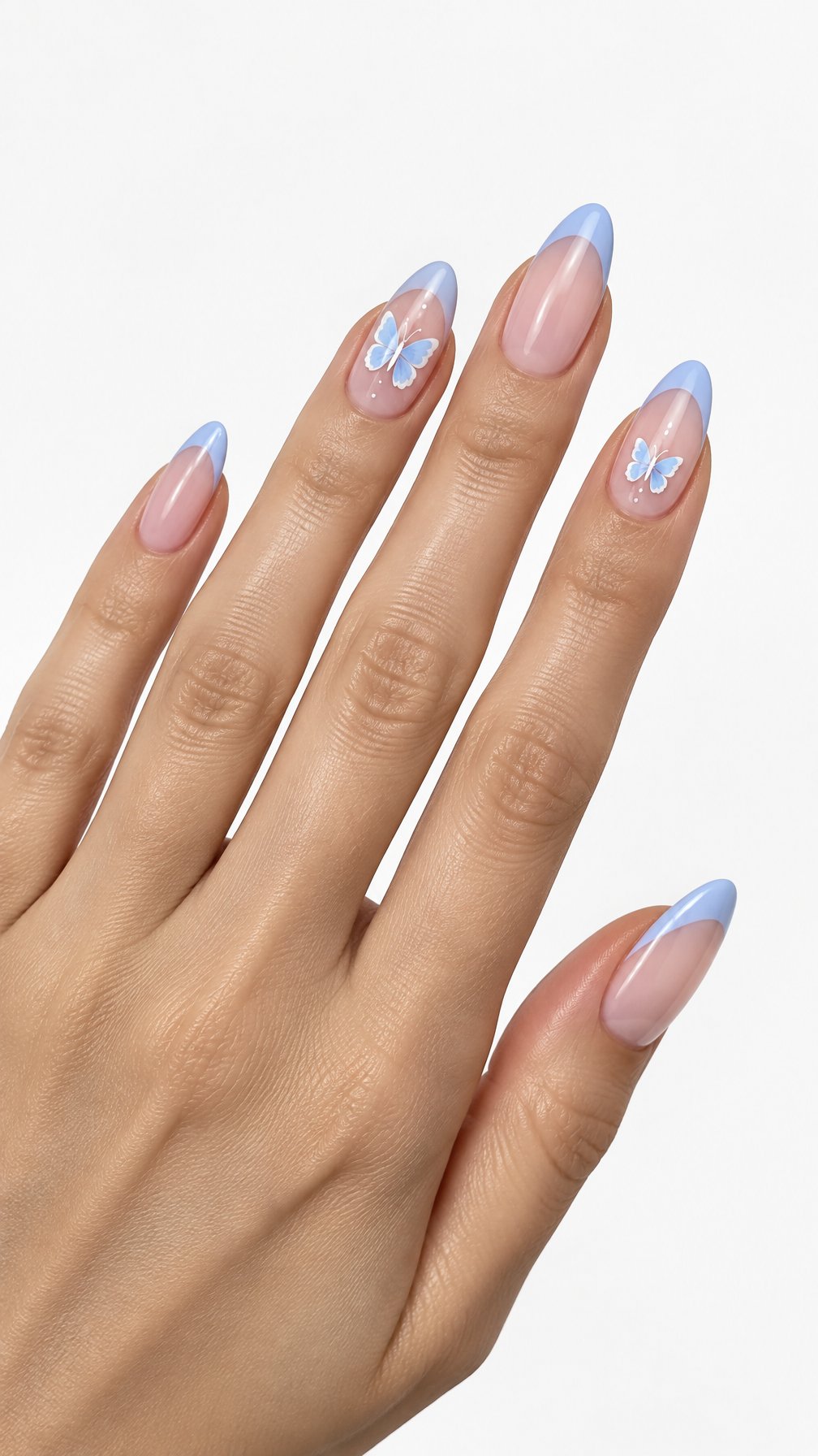 A single hand displays almond-shaped nails with pastel blue French tips and small butterfly designs against a white background.