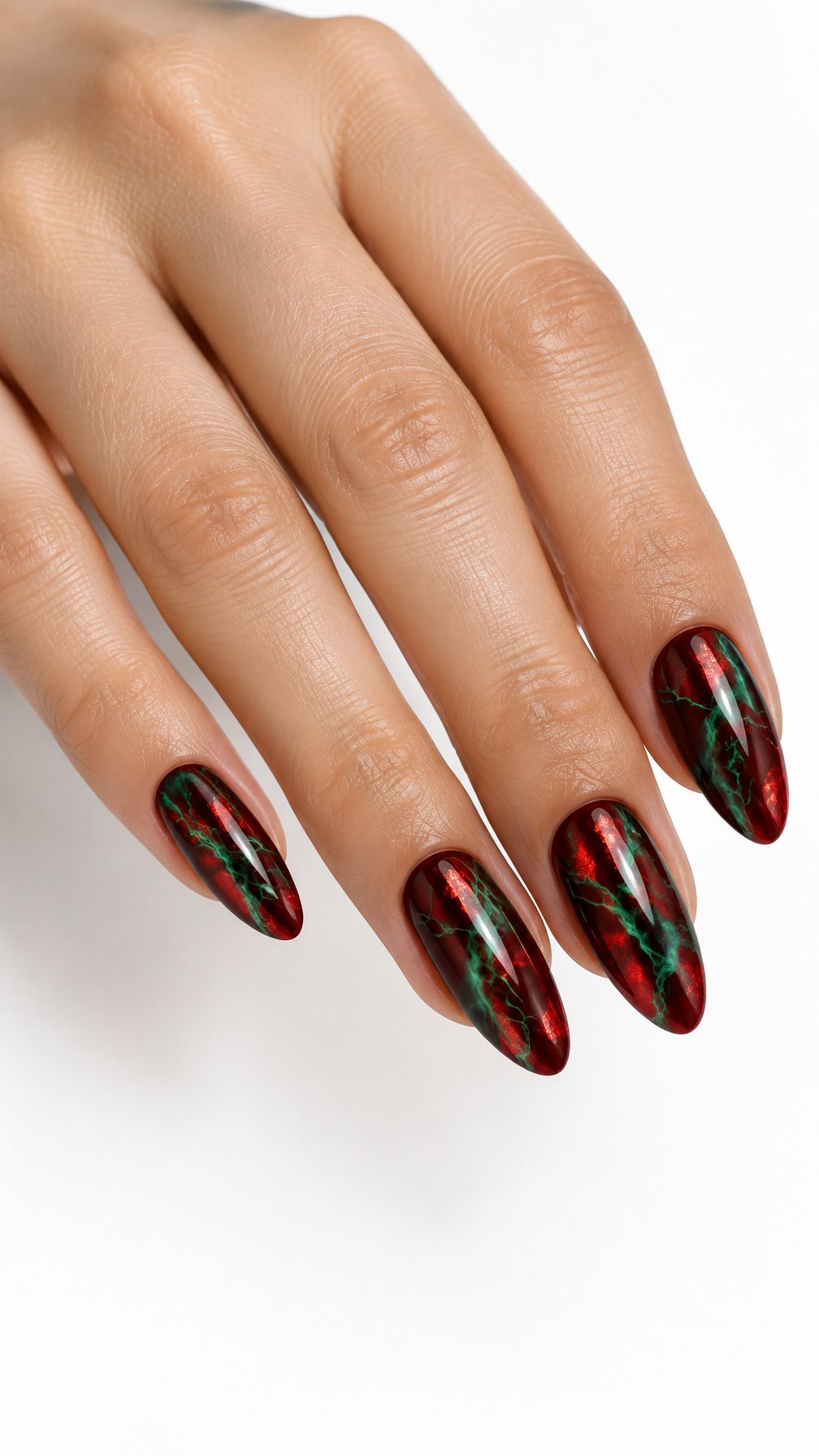 A single hand with glossy red nails decorated with green marble veining and metallic foil accents against a white background.