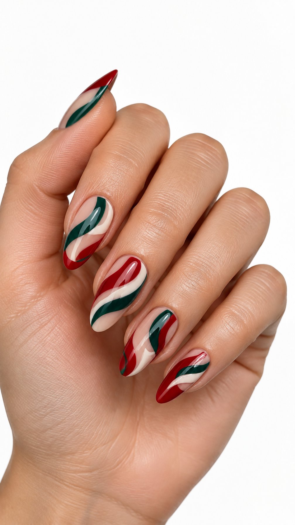 One hand with glossy red and green ribbon swirl nail art against a white background.