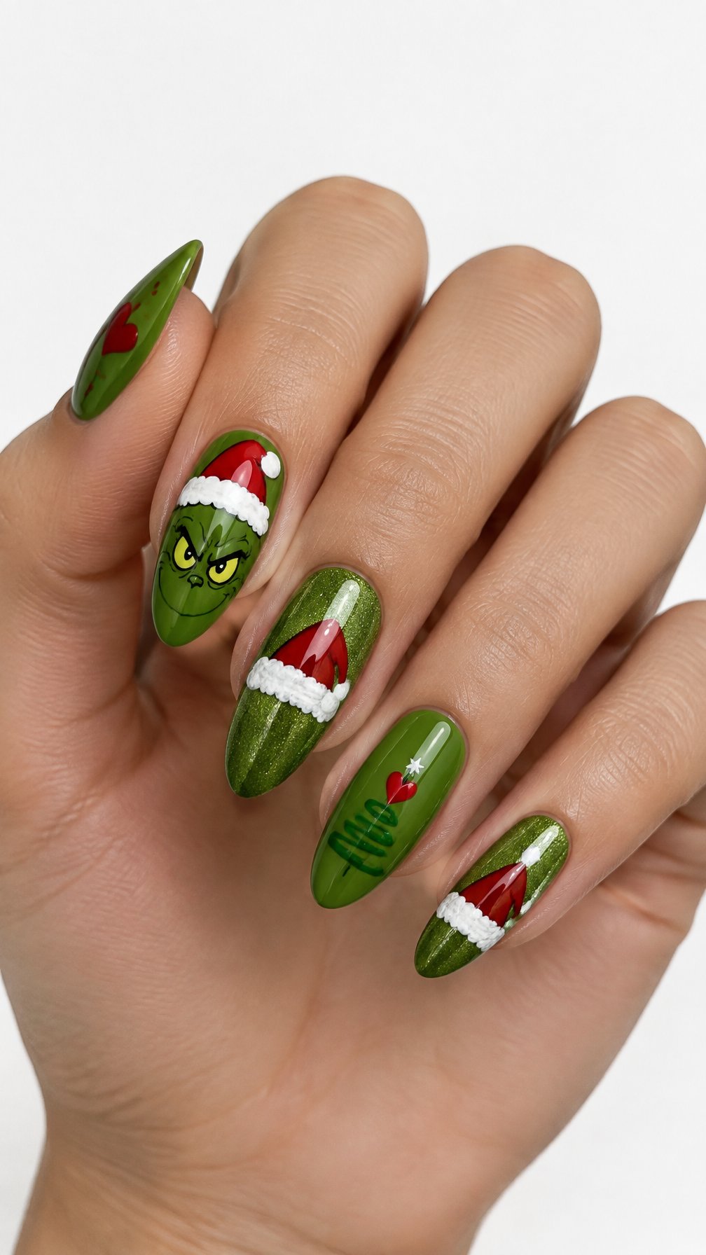 A single hand displays green Christmas nails decorated with red Santa hat designs against a white background.