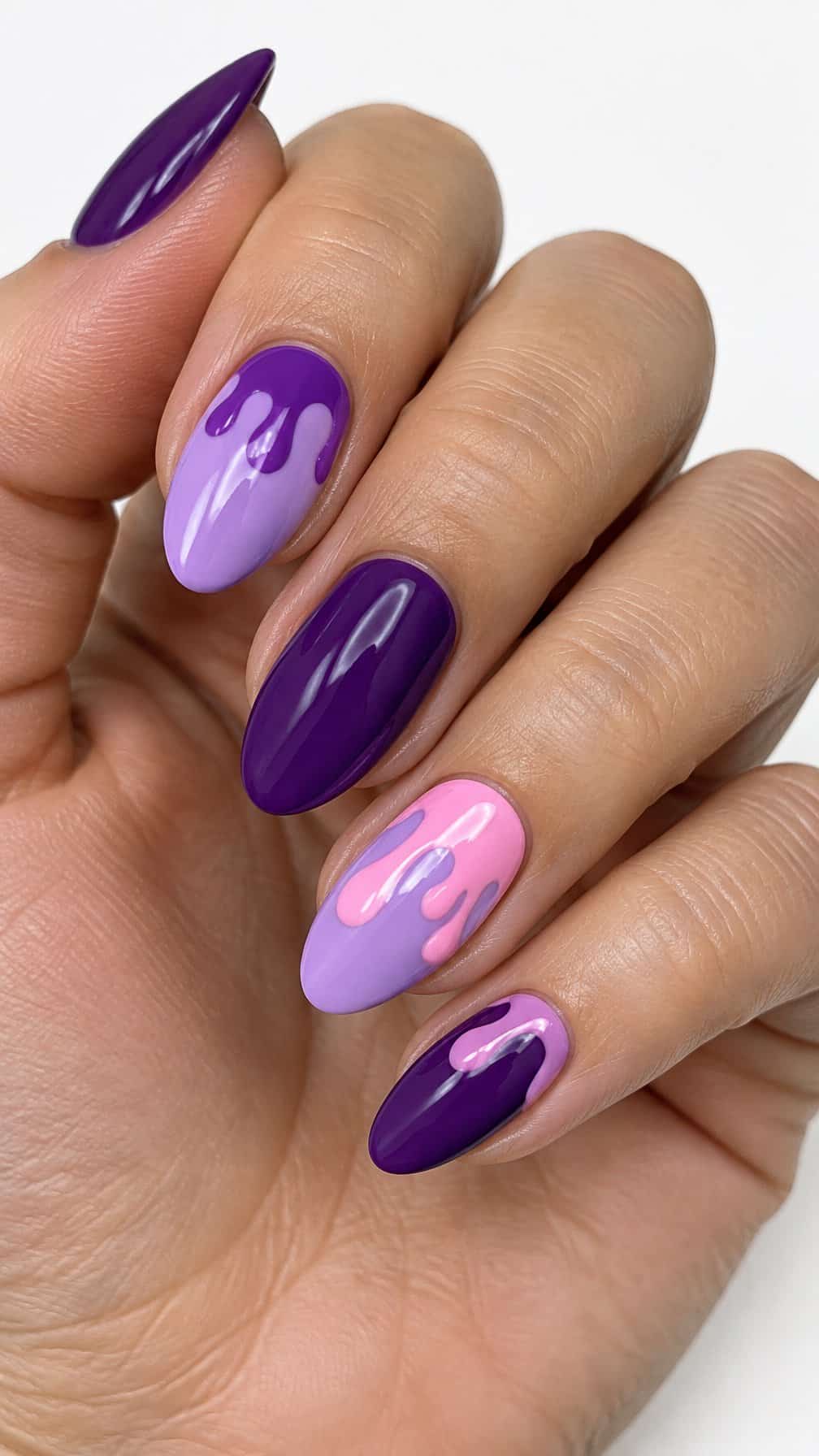 Glossy purple and lavender drip-design manicured nails