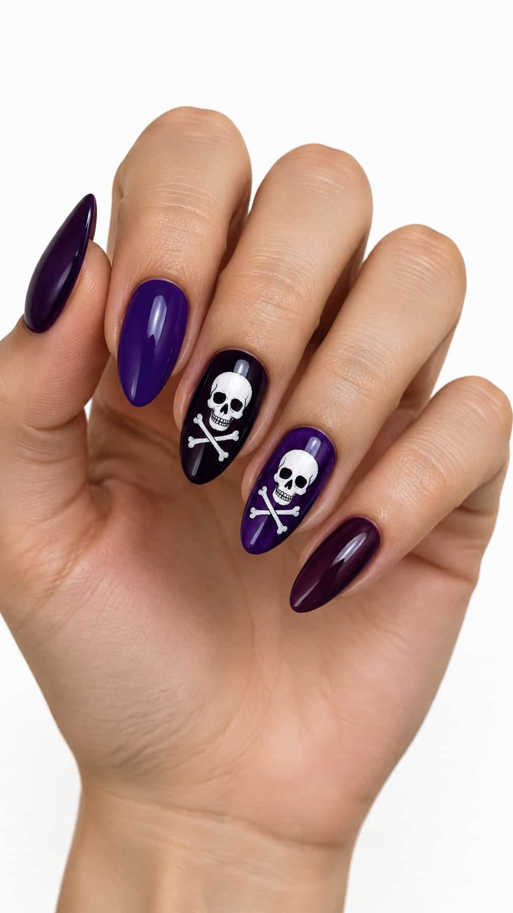 Glossy purple nails decorated with white skulls and crossbones