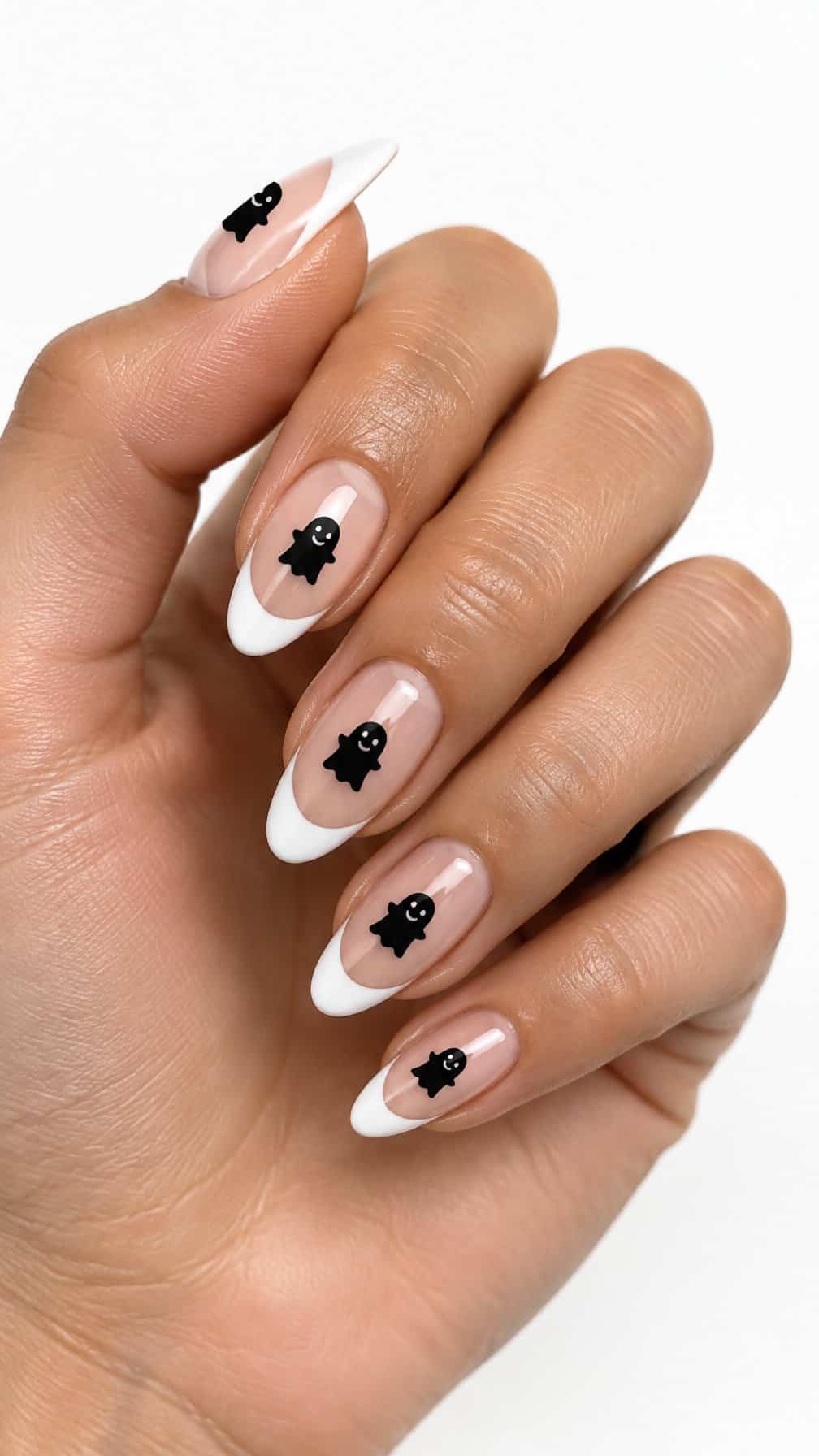 White French tip nails decorated with small black ghost silhouettes