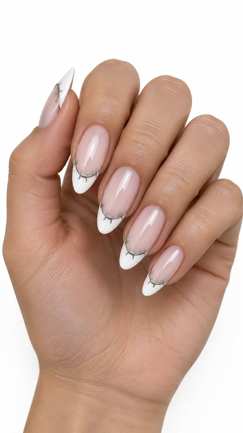 Glossy white French-tip nails decorated with delicate silver barbed-wire designs