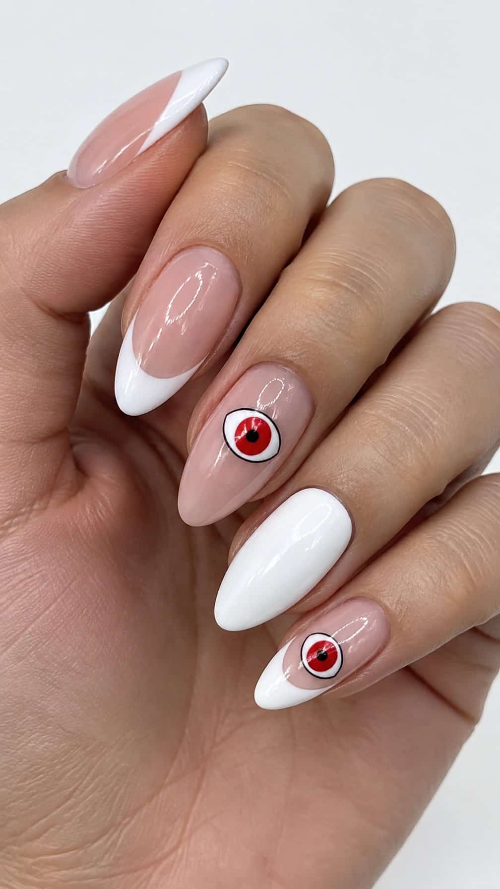 White French-tip nails and red eyeball designs on a few accent nails