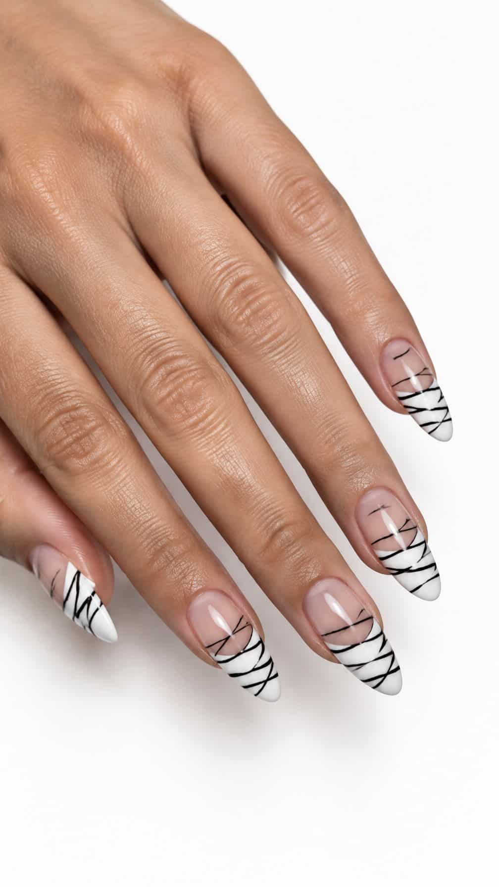White French-tip nails decorated with thin black mummy-wrap lines
