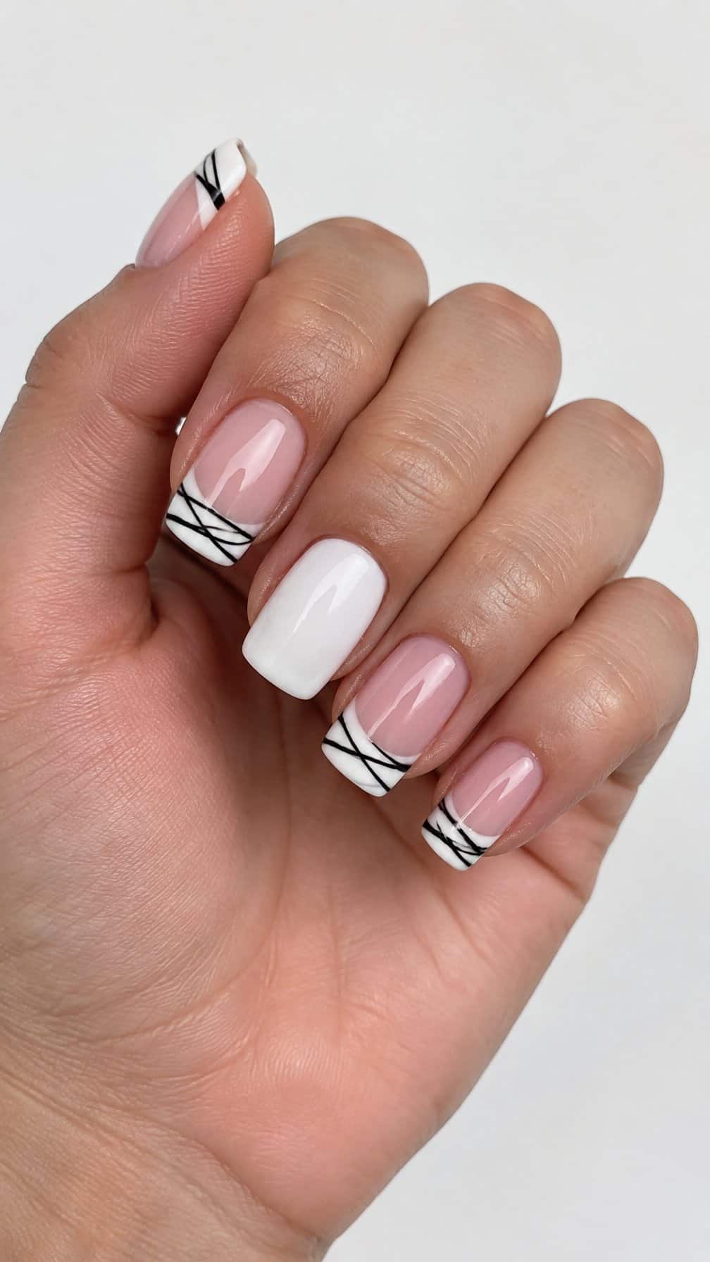 A white French-tip manicure with black mummy-wrap lines